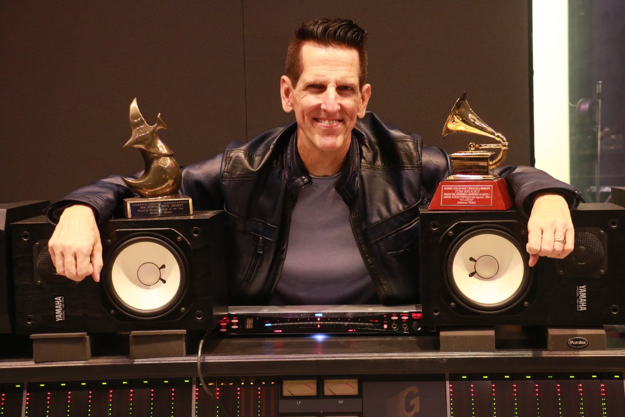 Tom Brooks at the mixing console, flanked by his Grammy and Dove awards